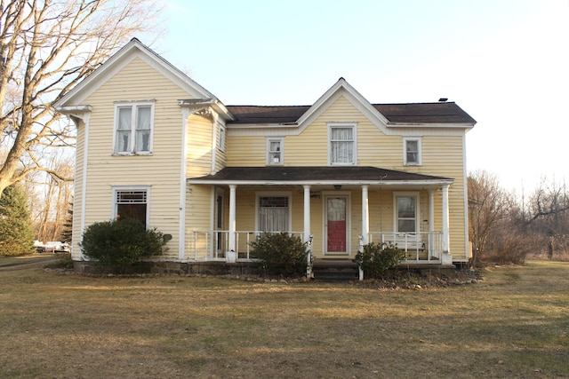view of front of home with covered porch and a front lawn