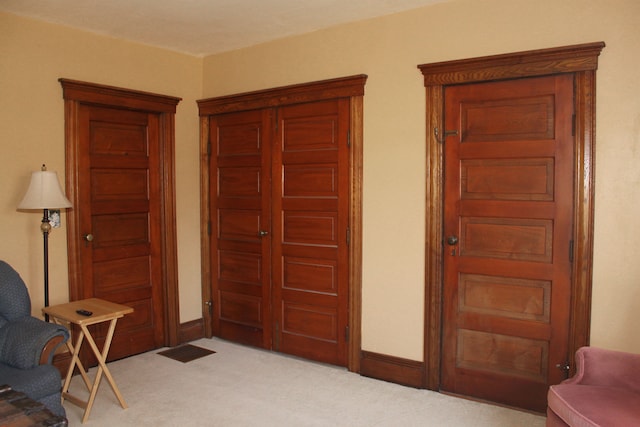 living area featuring baseboards and carpet