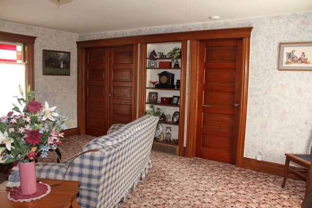 interior space featuring baseboards, wallpapered walls, and carpet flooring