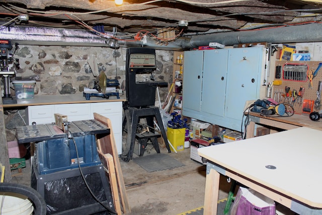 unfinished basement with a workshop area