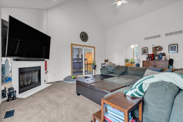 living room with visible vents, carpet flooring, and ceiling fan