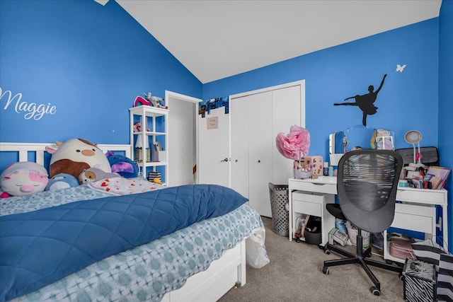 carpeted bedroom with a closet and vaulted ceiling