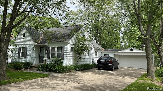 15882 Lennane, Redford, MI 48239 - view of front of home featuring an outdoor structure, a shingled roof, and a detached garage