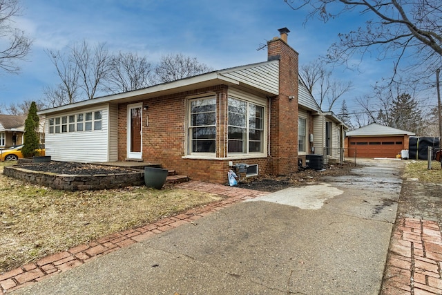 2174 Middlebelt Rd, West Bloomfield, MI 48324 - view of side of property with a chimney, an outdoor structure, brick siding, and a garage