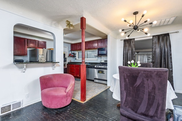 2174 Middlebelt Rd, West Bloomfield, MI 48324 - living room featuring an inviting chandelier, a textured ceiling, visible vents, and baseboards
