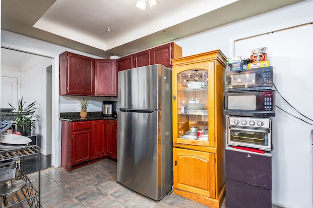 2174 Middlebelt Rd, West Bloomfield, MI 48324 - kitchen with freestanding refrigerator, black microwave, and reddish brown cabinets