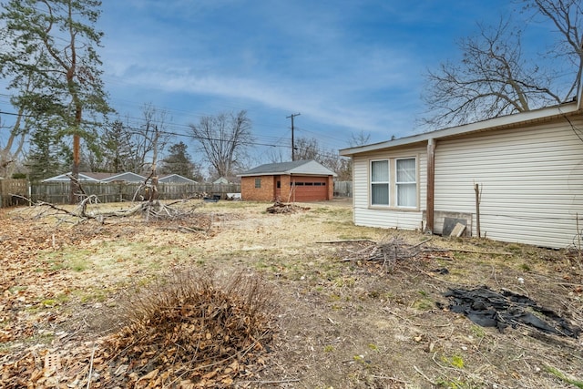 2174 Middlebelt Rd, West Bloomfield, MI 48324 - view of yard featuring fence and an outdoor structure