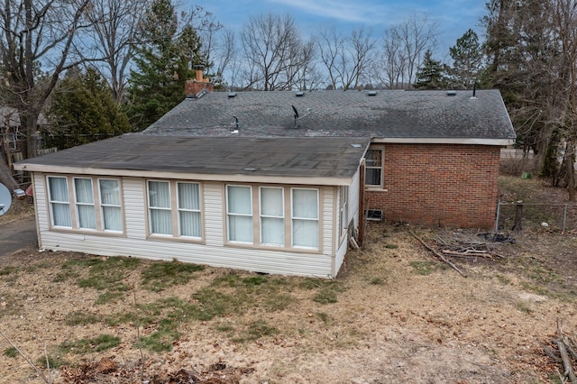 2174 Middlebelt Rd, West Bloomfield, MI 48324 - rear view of property with a shingled roof, brick siding, fence, and a chimney