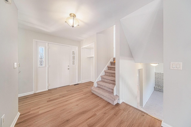 1019 Colony Dr, Saline, MI 48176 - entryway featuring stairway, baseboards, visible vents, and wood finished floors