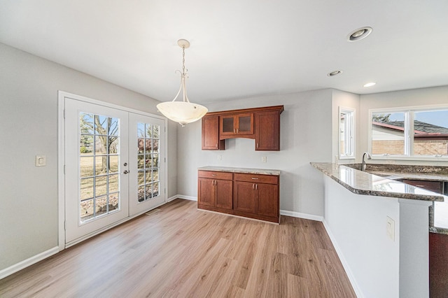 1019 Colony Dr, Saline, MI 48176 - unfurnished dining area with a wealth of natural light, french doors, baseboards, and light wood-style floors