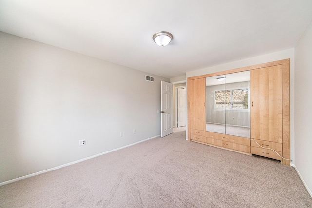 1019 Colony Dr, Saline, MI 48176 - unfurnished bedroom with visible vents, light carpet, baseboards, and a closet