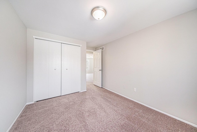 1019 Colony Dr, Saline, MI 48176 - unfurnished bedroom featuring a closet, carpet flooring, visible vents, and baseboards