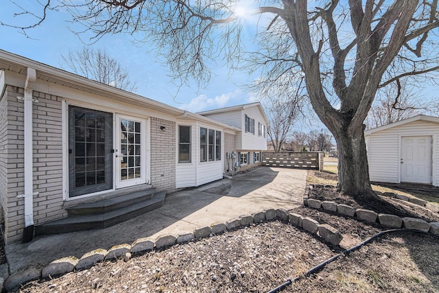 1019 Colony Dr, Saline, MI 48176 - exterior space featuring a patio area, entry steps, an outdoor structure, and fence