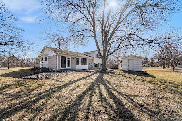 1019 Colony Dr, Saline, MI 48176 - exterior space with a shed, entry steps, an outdoor structure, a lawn, and brick siding