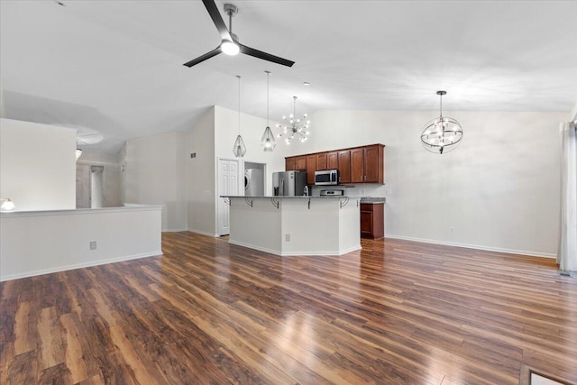 kitchen featuring dark wood-type flooring, ceiling fan with notable chandelier, open floor plan, and stainless steel appliances