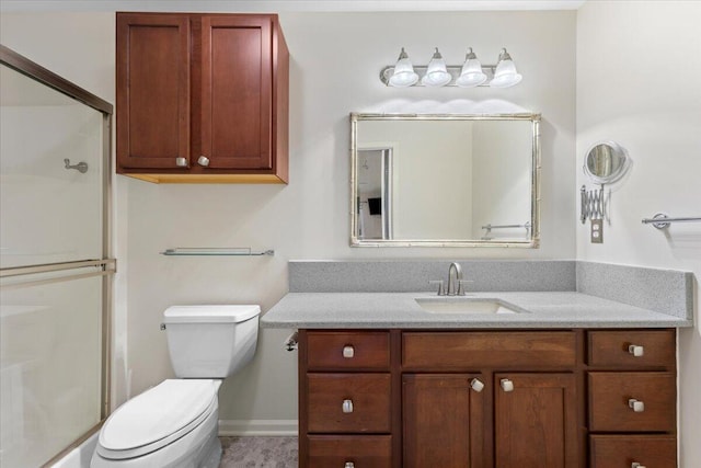 bathroom featuring a shower with shower door, toilet, and vanity