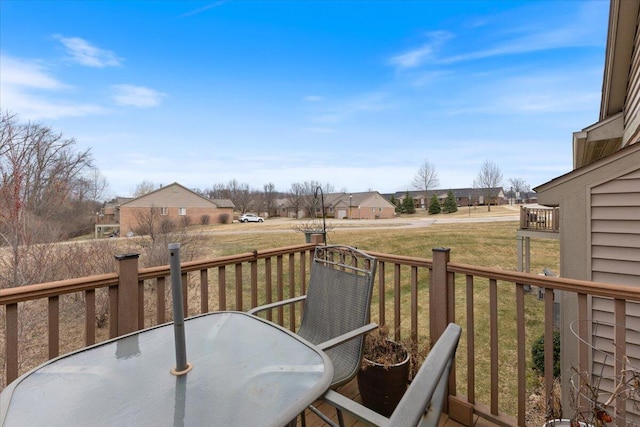 deck with a residential view and outdoor dining space