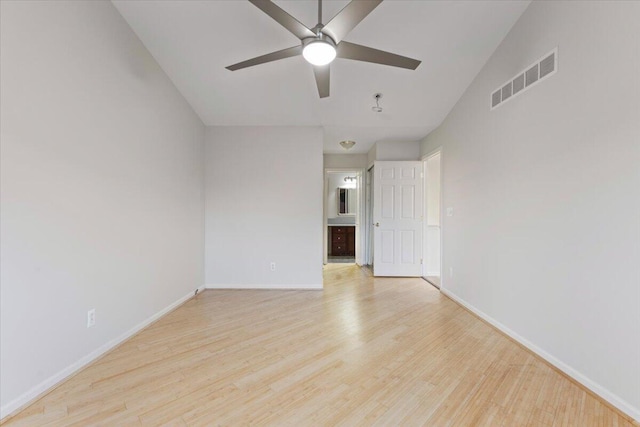 spare room with visible vents, baseboards, light wood-style floors, and ceiling fan