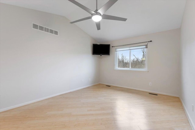 empty room with vaulted ceiling, light wood-style flooring, visible vents, and ceiling fan
