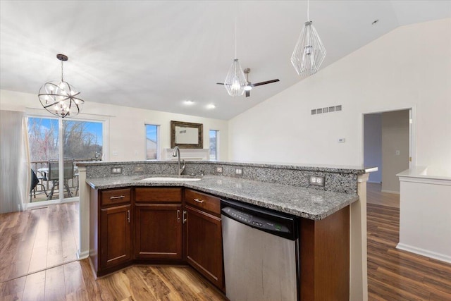 kitchen featuring stainless steel dishwasher, wood finished floors, visible vents, and a sink