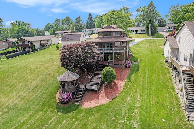 490 Skyline Dr, Horton, MI 49246 - back of house featuring stairway, a residential view, a gazebo, and a yard