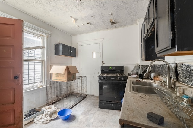 2251 Cortland St, Detroit, MI 48206 - kitchen featuring black range with gas stovetop, a textured ceiling, light countertops, and a sink