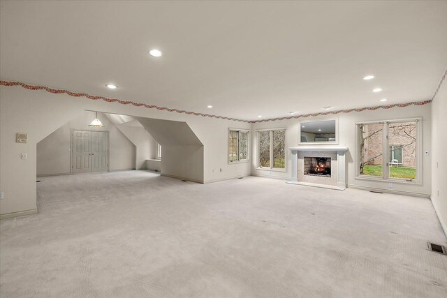 1632 Scenic Hollow Dr, Rochester Hills, MI 48306 - unfurnished living room with recessed lighting, visible vents, carpet, and a warm lit fireplace