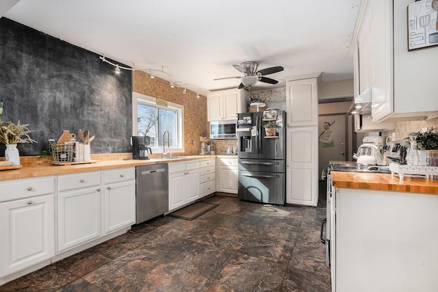 10172 US Highway 12, New Buffalo, MI 49117 - kitchen featuring ceiling fan, butcher block counters, appliances with stainless steel finishes, white cabinetry, and a sink