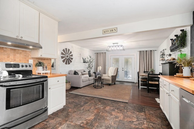 10172 US Highway 12, New Buffalo, MI 49117 - kitchen with under cabinet range hood, decorative backsplash, wooden counters, white cabinets, and appliances with stainless steel finishes