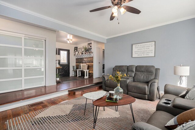 10172 US Highway 12, New Buffalo, MI 49117 - living room with a fireplace, ceiling fan, ornamental molding, and hardwood / wood-style floors