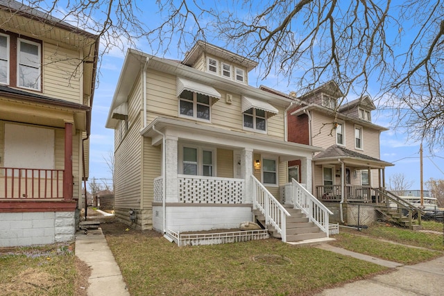 traditional style home with a front yard and covered porch