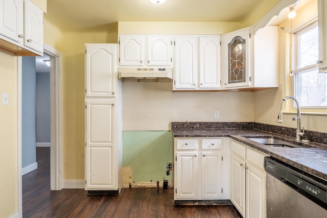 kitchen with dark wood-type flooring, white cabinetry, under cabinet range hood, dishwasher, and a sink