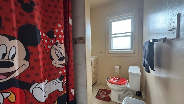 full bath featuring a shower with curtain, toilet, and tile patterned flooring