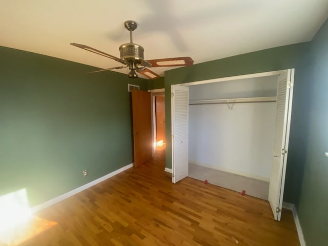 6111 Woodmoor Dr, Burton, MI 48509 - unfurnished bedroom with baseboards, visible vents, wood finished floors, and a closet
