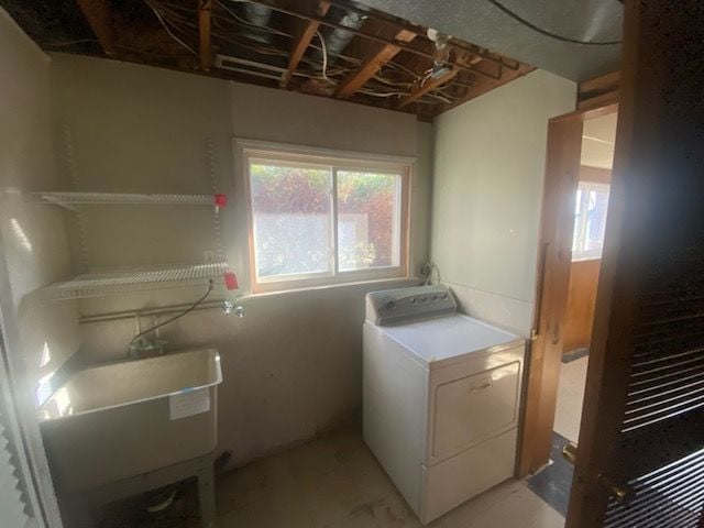 6111 Woodmoor Dr, Burton, MI 48509 - clothes washing area with a sink, washer / dryer, and laundry area