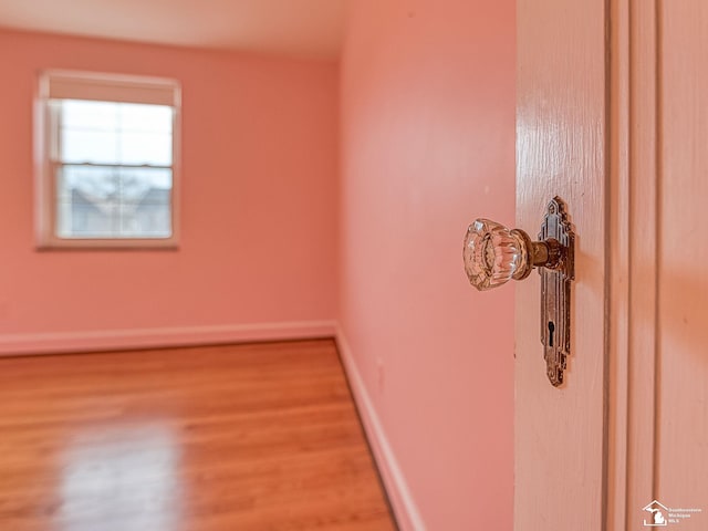 spare room with wood finished floors