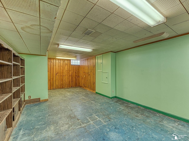 basement with wooden walls and baseboards