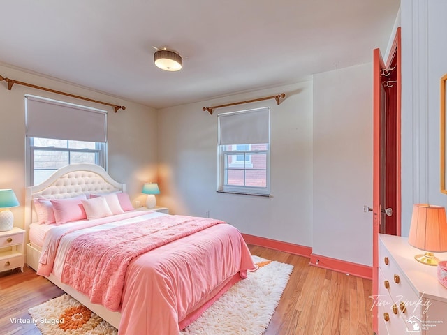 bedroom featuring baseboards and light wood-style floors
