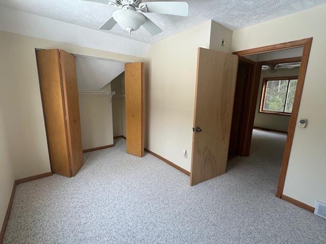 bonus room featuring light carpet, a textured ceiling, baseboards, and a ceiling fan