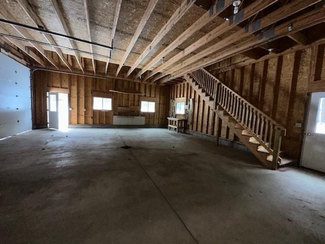 misc room with concrete floors and a garage