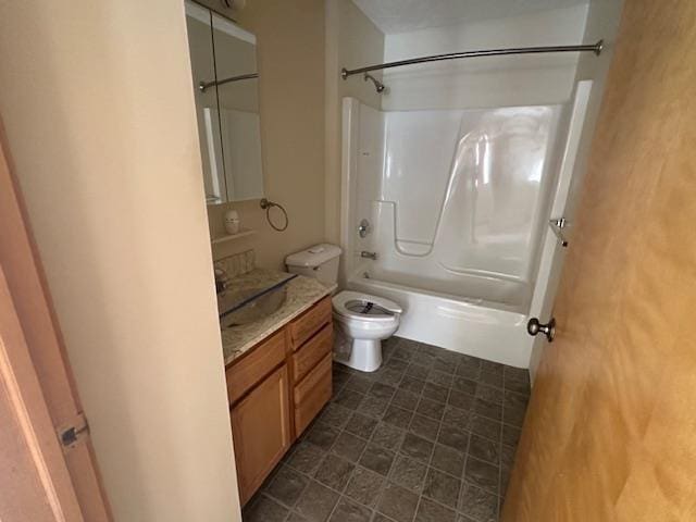 full bathroom with toilet, vanity, and washtub / shower combination