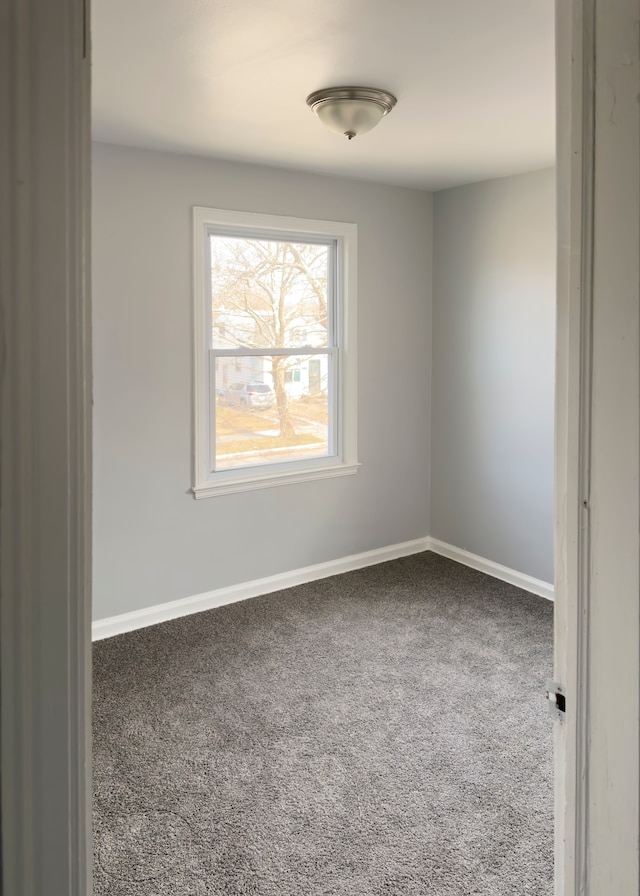carpeted spare room with baseboards