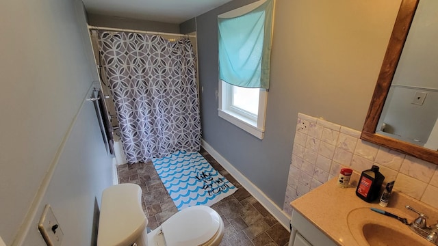 135 Handley St, Imlay City, MI 48444 - bathroom with decorative backsplash, vanity, a shower with curtain, stone finish flooring, and toilet