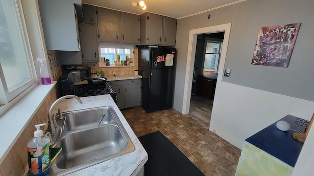 135 Handley St, Imlay City, MI 48444 - kitchen featuring black appliances, gray cabinetry, light countertops, backsplash, and stone finish floor