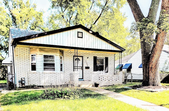 view of front of home with brick siding and fence