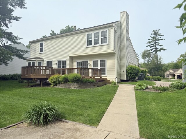 3023 Holben Dr, Lake Orion, MI 48360 - rear view of property with a deck, a lawn, and a chimney