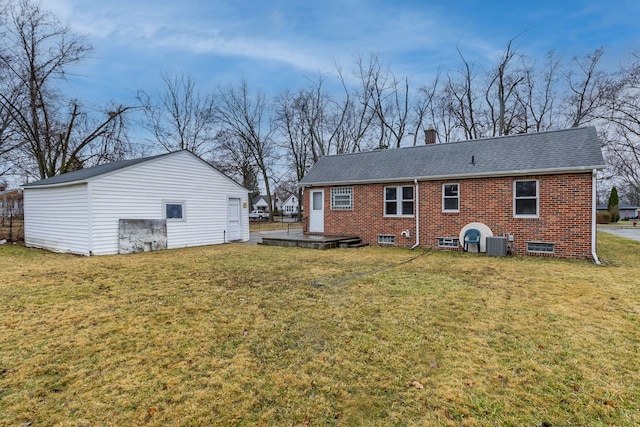 back of house featuring central AC unit, roof with shingles, a yard, a chimney, and brick siding