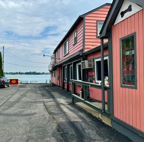 147 S Water St, Marine City, MI 48039 - view of property exterior featuring a wall unit AC and a water view