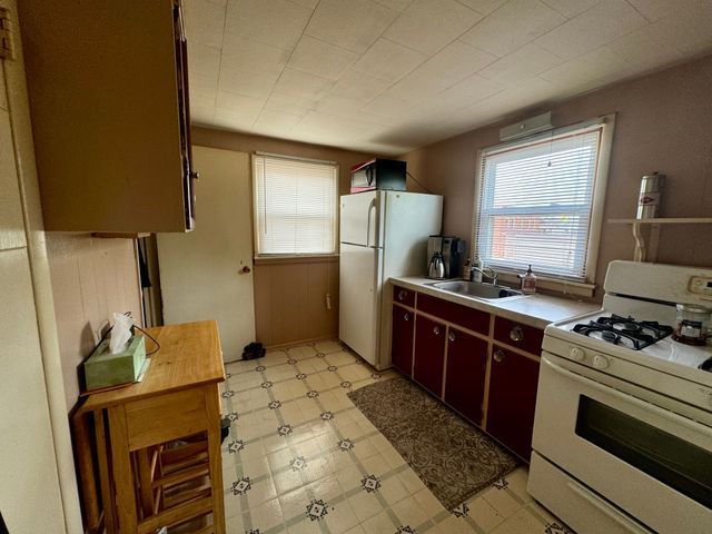 147 S Water St, Marine City, MI 48039 - kitchen with a sink, white appliances, light floors, and light countertops