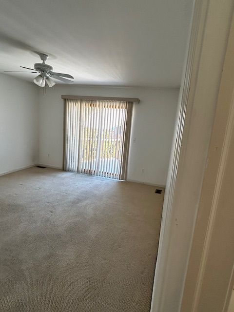26766 Plumgrove Ln Unit 56, Farmington Hills, MI 48334 - spare room with a ceiling fan, visible vents, and carpet